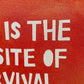 close up photo of original painting by britchida showing block lettering on red orange paint