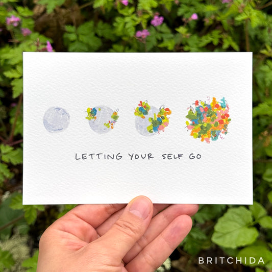 a series of four gray globes — the first one bare, the next ones each with increasing amounts of abstract color marks on them in a floral motif until the last one which is fully covered. Below is the text, “letting yourself go”