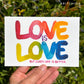 written in watercolor paint: “love is love” and then in small writing below “but queer love is better”