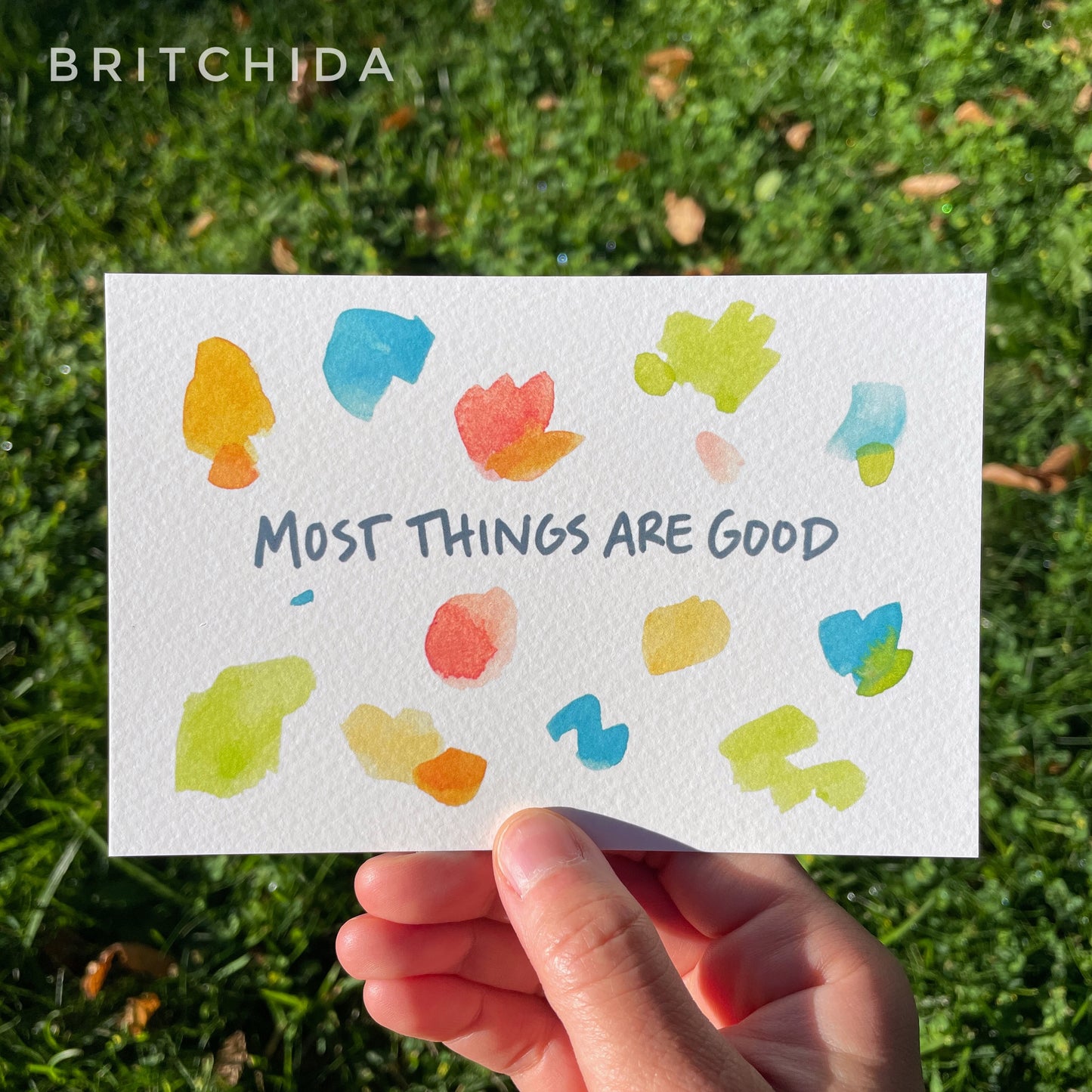 The text "most things are good" in set among many small, irregular colorful shapes.