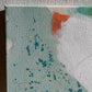 close up photo of original abstract painting by britchida with teal, orange, green, and white shapes on canvas