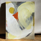 original abstract painting by britchida with yellow, gray, orange, and white shapes on canvas