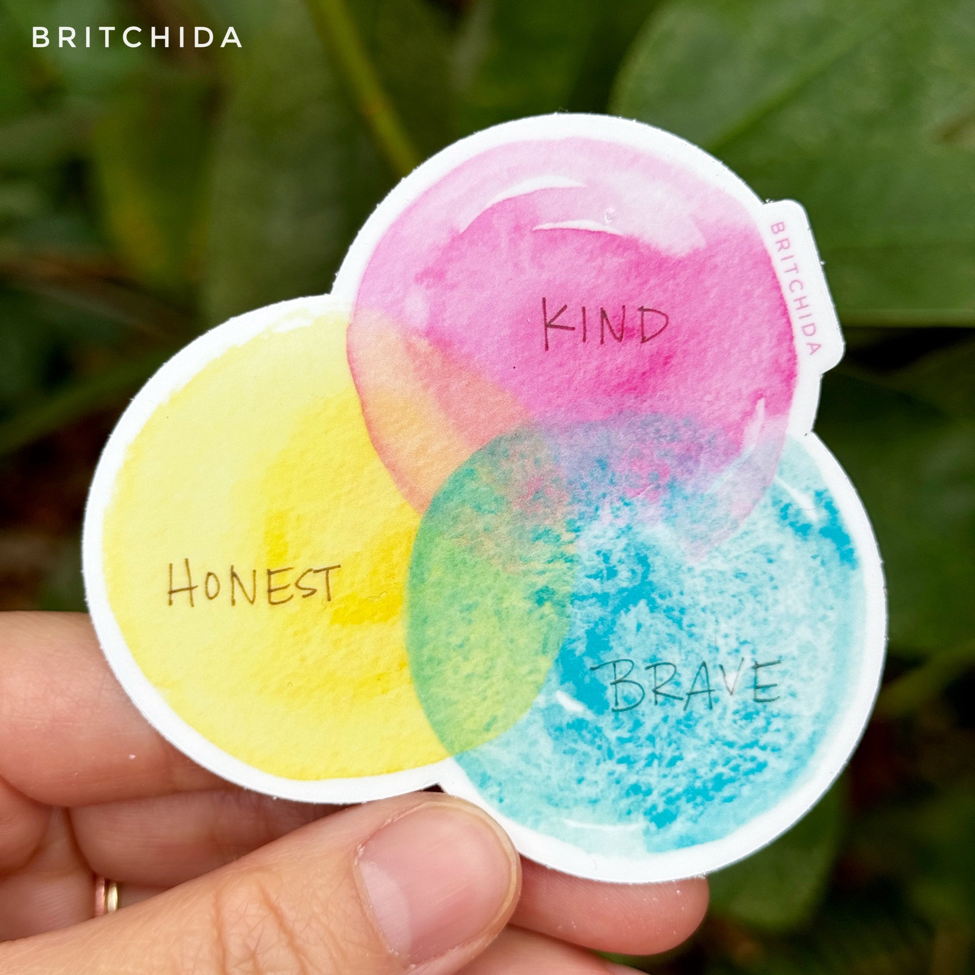 sticker of Kind Honest Brave print with 3 overlapping circles in pink "Kind", yellow "honest" and blue "brave"