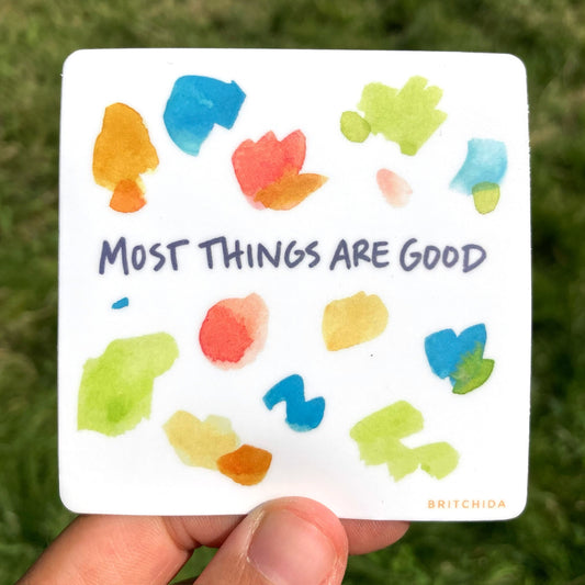 sticker of Most Things Are Good print with various watercolor paint shapes in in orange, blue, red, and green and the text "most things are good"