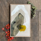 framed original abstract painting by britchida with yellow, white, peach and gray shapes with thin lines on tan canvas laying on floor with orange japanese maple leaves in the lower left corner and moss and lichen covered branch in upper right corner