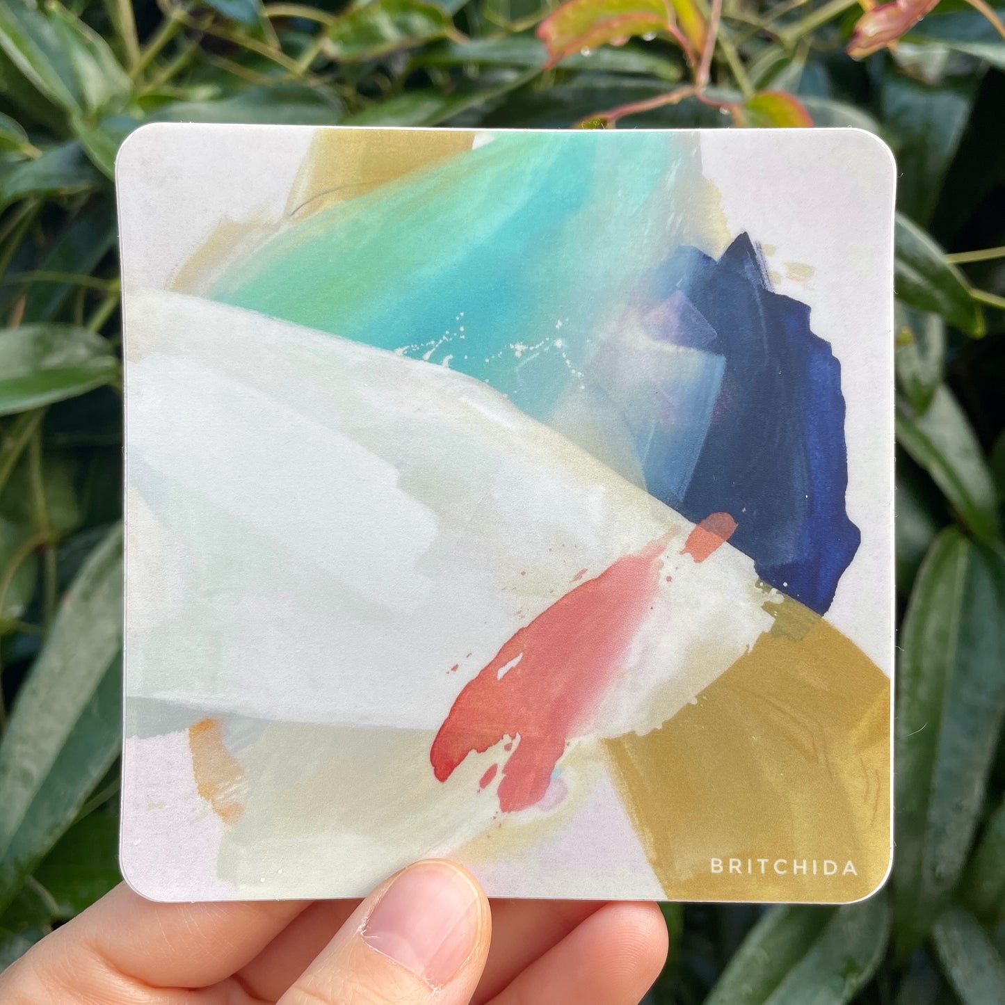 sticker of EASE abstract painting with various shapes in navy, teal, pink, yellow/tan, and white