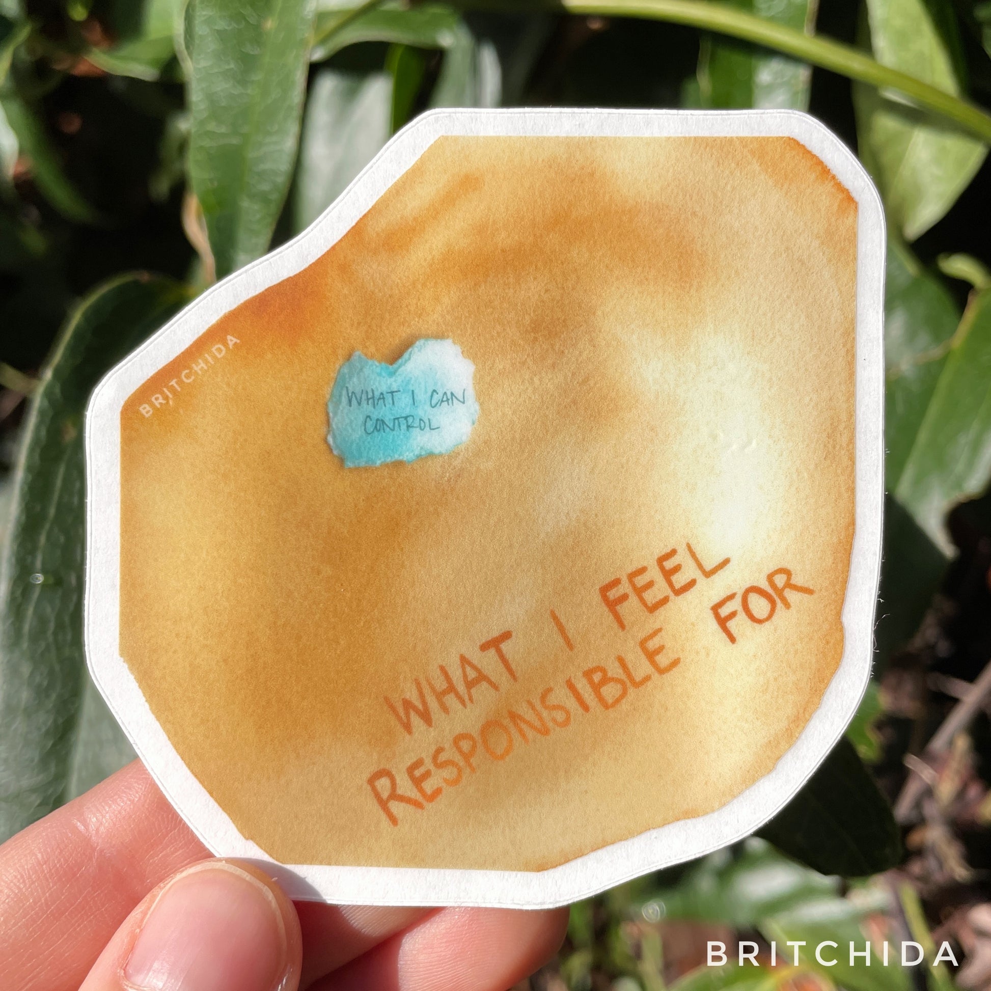 sticker of So Responsible print with large orange gold blob with the text "what I feel responsible for" and a small blue shape with the text "what I can control" on top of the orange shape.